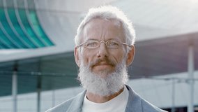 Smiling happy mature older bearded business man leader, smiling middle aged senior professional businessman ceo wearing suit and glasses laughing looking at camera outside, headshot portrait. - Powered by Shutterstock - Get 15% off with code: PIKWIZARD15