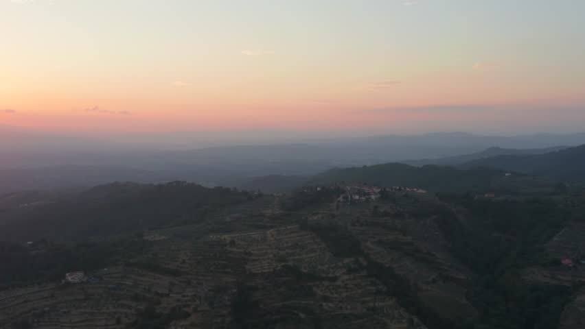 Sunset light over Tuscany Italy landscape and hills. Golden orange yellow red glow morning light. Aerial drone flight over open nature. vacation dream