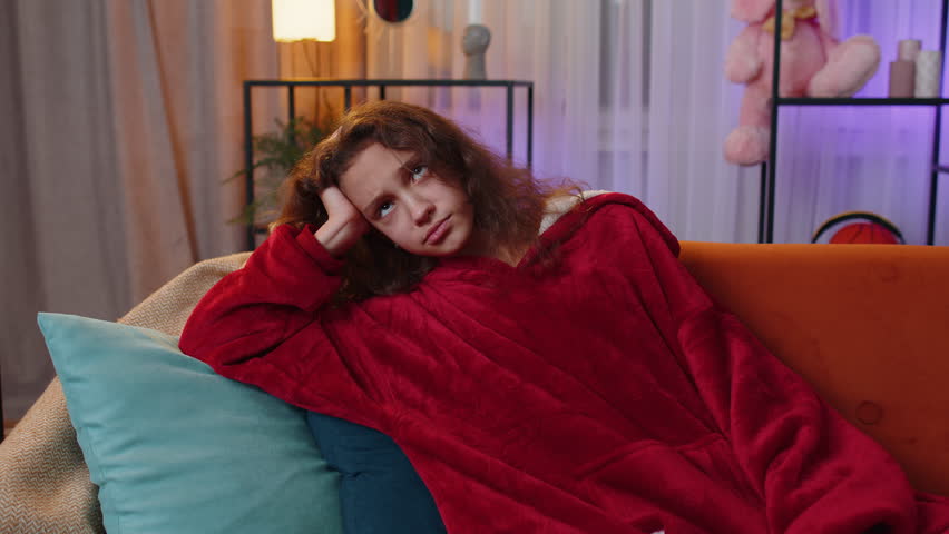 Sad lonely preteen girl at home looks pensive thinks over life concerns or unrequited love, suffers from unfair situation. Young child, kid problem, break up, depressed feeling bad annoyed burnout