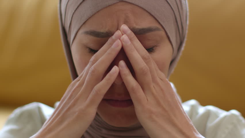 Stress and despair concept. Close up portrait of nervous unhappy muslim woman wearing traditional lady crying, feeling depressed and worried | Shutterstock HD Video #1099560341