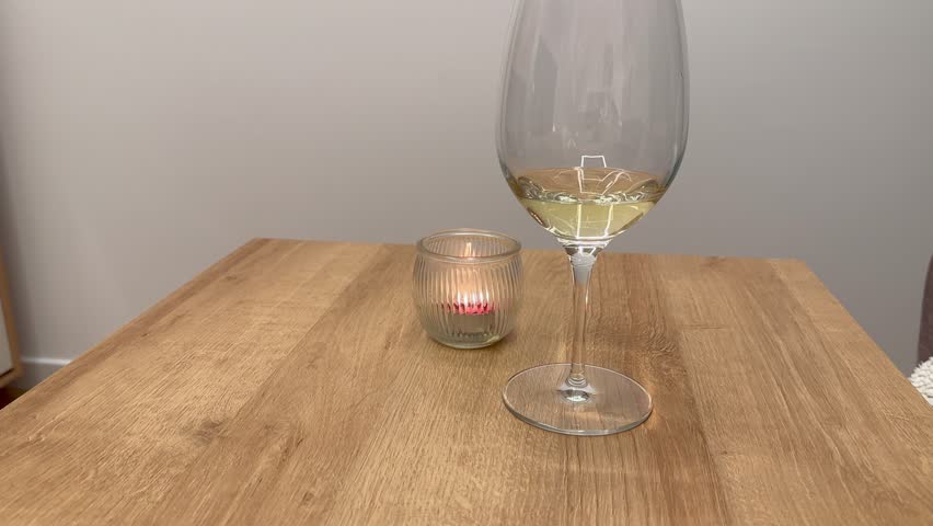 Drinking a small glass of white wine | Shutterstock HD Video #1099560465
