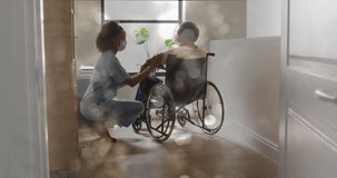 Animation of bokeh over diverse doctor and patient sitting in wheelchair. Medicine, healthcare and lifestyle concept digitally generated video.