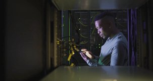 Animation of data processing over african american male it engineer and computer servers. Global computing and data processing concept digitally generated video.
