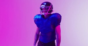 Animation of confetti falling over american football player on pink background. Sports and communication concept digitally generated video.