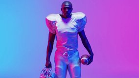 Animation of you win text over american football player on neon background. Sports, competition and communication concept digitally generated video.