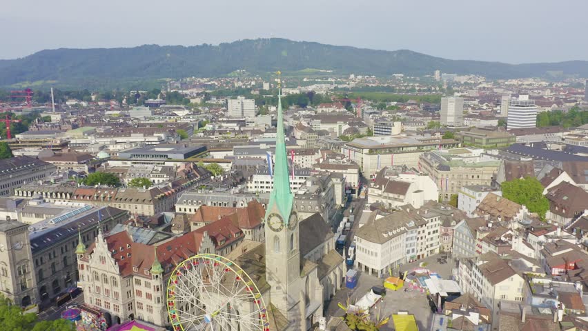 Inscription on video. Zurich, Switzerland. Panorama of the city from the air. Fraumunster Church. Shimmers in colors purple, Aerial View, Point of interest