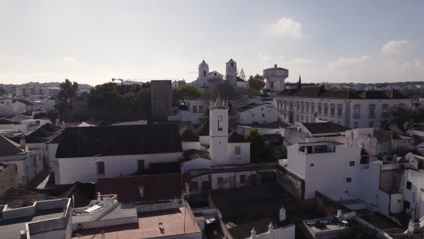 Tavira aerial cityscape, Portugal. Church of Santa Maria do Castelo at the distance on a sunny day | Shutterstock HD Video #1099572373