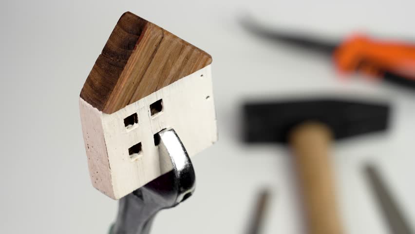 Home improvement concept. House model in wrench with tools in blur