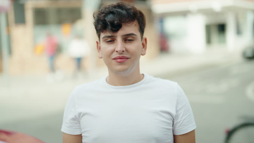 Non binary man smiling confident standing at street | Shutterstock HD Video #1099581461