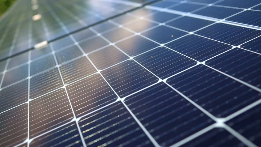 Closeup of surface of blue photovoltaic solar panels mounted on building roof for producing clean ecological electricity. Production of renewable energy concept.  Royalty-Free Stock Footage #1099583317