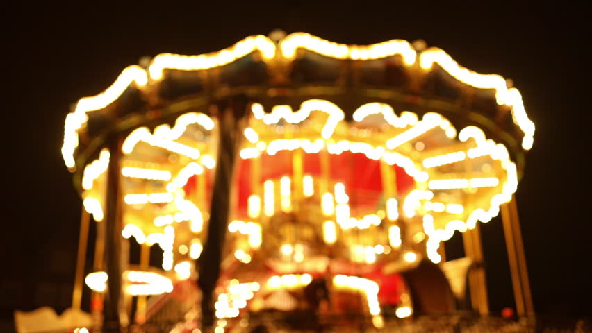 Old carousel in the park. Three horses and a plane on a traditional fair carousel at night. Carousel with horses during a summer evening in Poland. Blurred background Royalty-Free Stock Footage #1099583329