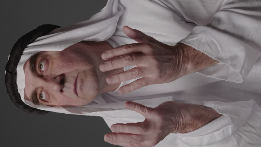 Man with united arab emirates traditional clothes posing in a studio. Beautiful islamic portrait of portrait arab businessman kandur. Studio footage with different poses