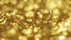 Gold fluid. Golden shiny liquid waving in slow motion with a narrow depth of field. Festive gold bokeh animation video background.
