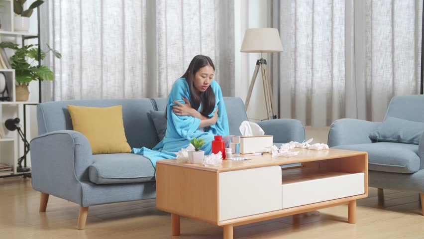 Sick Asian Woman With Blanket Being Cold On Sofa In The Living Room At Home
 | Shutterstock HD Video #1099588433