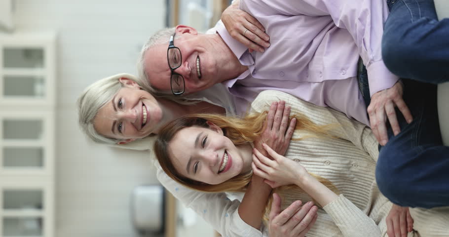 Happy friendly multi generational people posing smile staring at cam sit on sofa at home. Loving mature daughter, teenage granddaughter spend time visit their older dad grandfather. Unity, family ties | Shutterstock HD Video #1099588937
