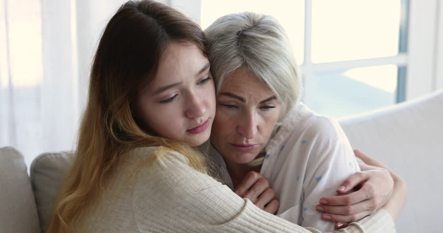 Loving teenage 13s daughter cuddling frustrated middle-aged mother, embracing her express love and caress, consoling, talking, gives psychological support, share mental pain, close up. Family, care | Shutterstock HD Video #1099588959