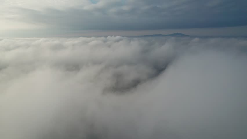 Flight in the clouds at low altitude. View from the cockpit of an airplane, glider.