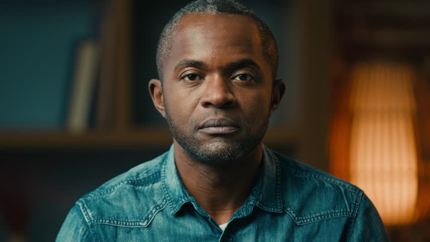 Close-up male portrait serious sad lonely mature african american man looking at camera desperate unhappy hopeless middle-aged ethnic businessman posing indoors crisis problem concept moving footage | Shutterstock HD Video #1099590781
