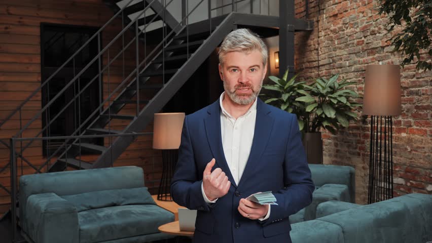 Rich happy confident businessman holds pack of money, tells how to earn it. Huge wealth of money. Employee salary. Cash money payment. Financial business, profit, income. Successful business concept. | Shutterstock HD Video #1099591777