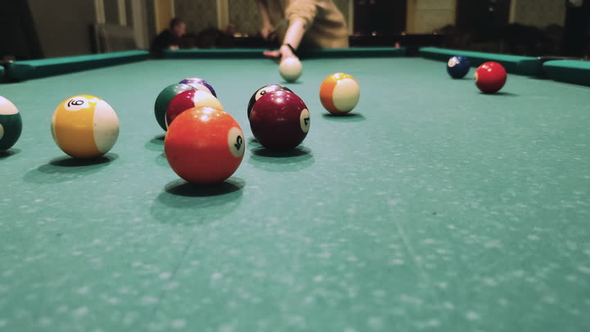 A man breaks a triangle of balls billiards pool. 4k footage video | Shutterstock HD Video #1099596807
