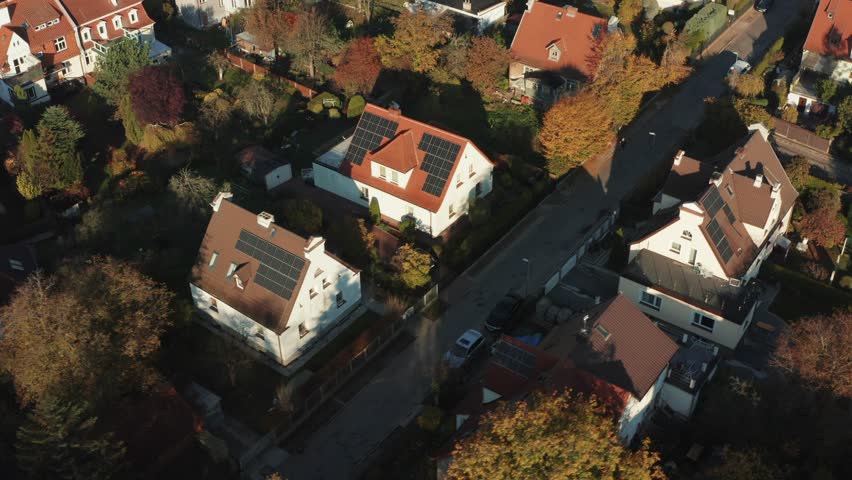 Solar panels on the roofs of private houses of houses for the production of clean electricity in a modern European city. aerial view of private houses with solar panels on roofs  Royalty-Free Stock Footage #1099597175