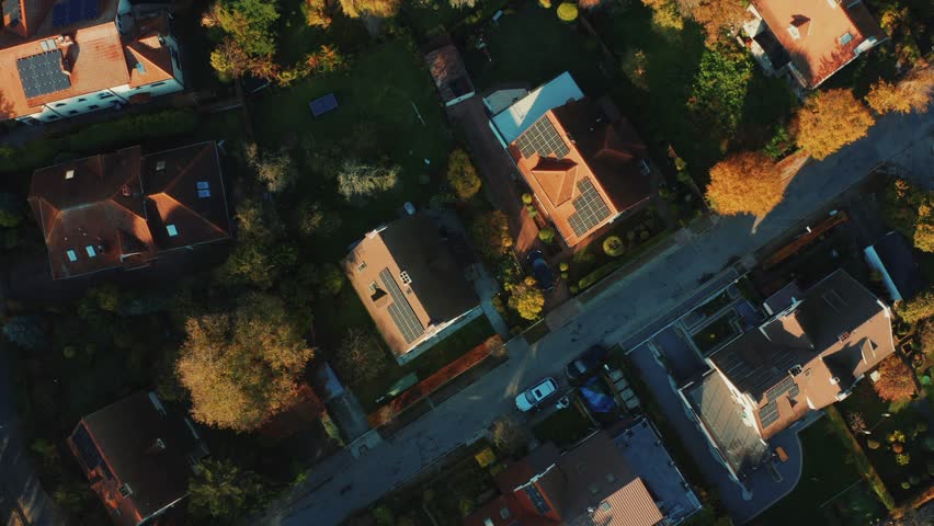 Cinematic shot of a drone on solar panels mounted on the roofs of modern country houses in a modern city. Production of clean renewable electricity. Solar energy on a sunny evening.  Royalty-Free Stock Footage #1099597227
