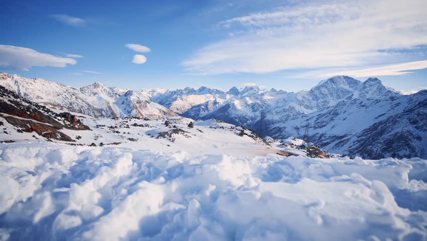 Top view of mountain to snow-covered mountain range. Beautiful winter nature outdoors landscape. Ski resort on top of hill. Adventure, travel, tourism, vacation, relax alone. Active lifestyle. | Shutterstock HD Video #1099598699