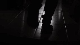 close-up of a latin man's feet, walking down a very dark hallway. walking in the shadows. - Powered by Shutterstock - Get 15% off with code: PIKWIZARD15