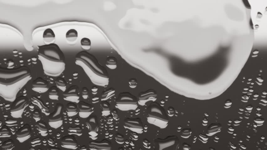 Two small water drops drip on big one splashing and creating ripples on it on grey background | Body hydration concept | Shutterstock HD Video #1099601675