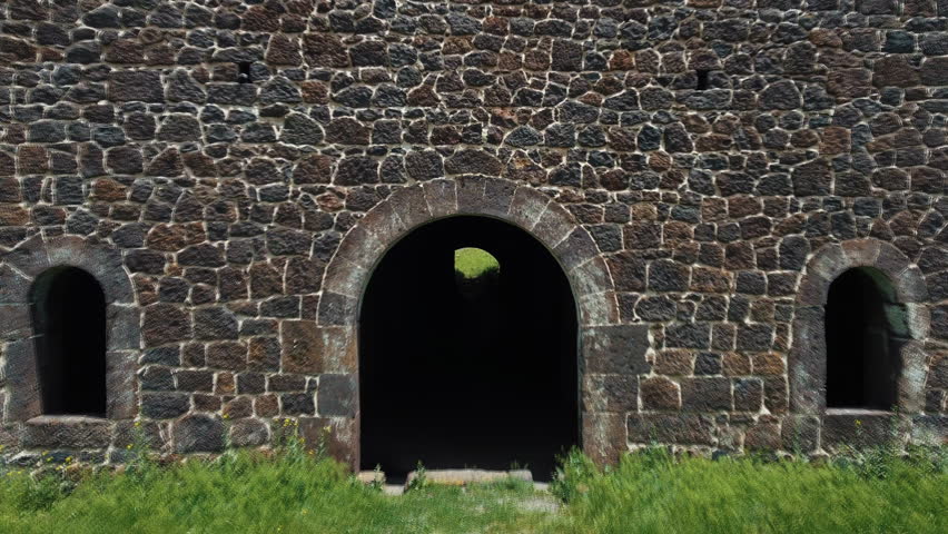 Ottoman empire defense lines. It is a historical and military building. It is found in Turkey and the city of Erzurum. It is a high altitude city. The camera moves back through the arched doors.