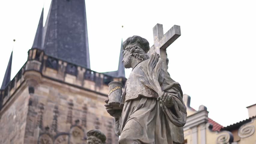 Prague Charles Bridge statue. Czech Republic historic landmark. Summer tourism travel destination in Europe.