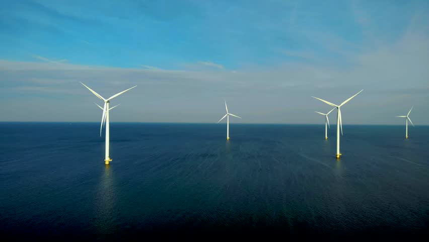 Offshore windmill park with clouds and a blue sky, windmill park in the ocean aerial view of wind turbine Flevoland Netherlands Ijsselmeer. Green energy.  | Shutterstock HD Video #1099607469