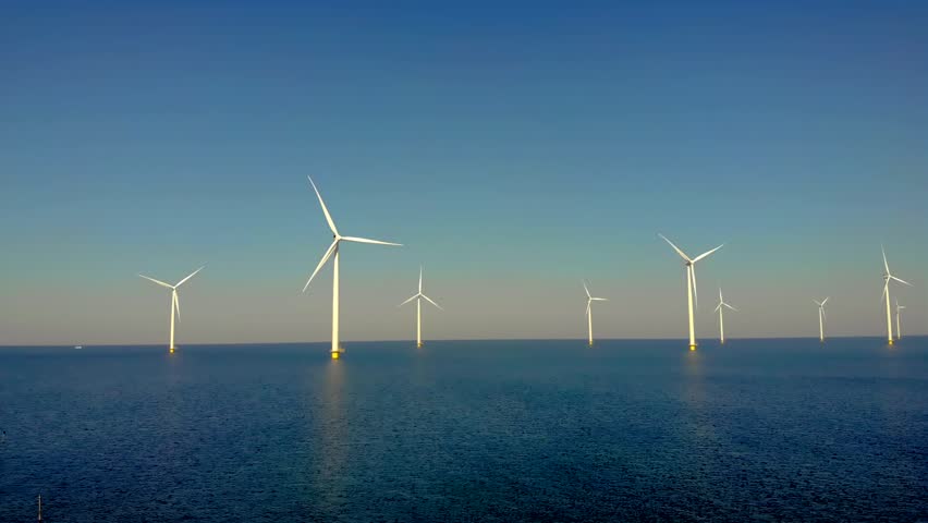 Offshore windmill park and a blue sky, windmill park in the ocean aerial view with wind turbine Flevoland Netherlands Ijsselmeer. Green energy.  | Shutterstock HD Video #1099607561