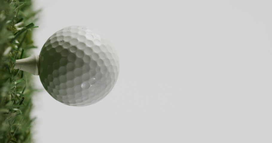 Vertical viedo of golf ball on grass and white background, copy space, slow motion. Golf, sport and hobby concept. | Shutterstock HD Video #1099607997