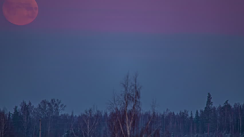 Massive bloody moon setting down into grey cloudscape, fusion time lapse