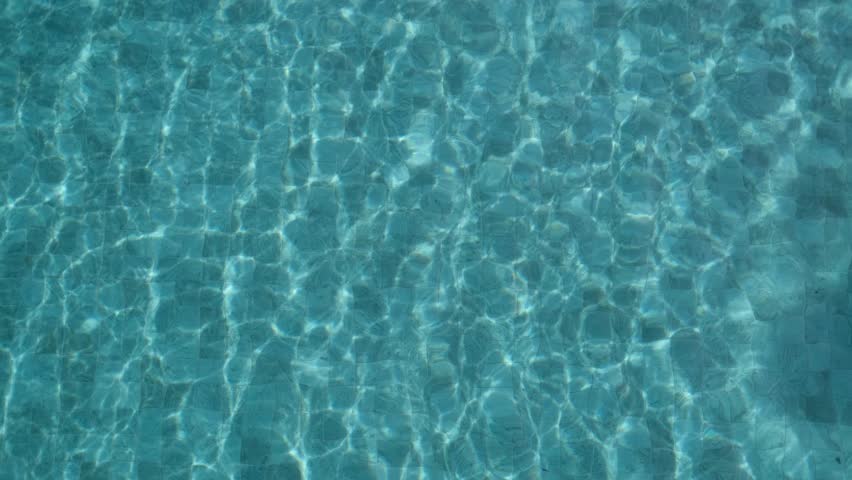A happy little girl in scuba goggles is swimming underwater in the pool. Healthy lifestyle, water sports, outdoor adventures, family holidays with a child, summer holidays.