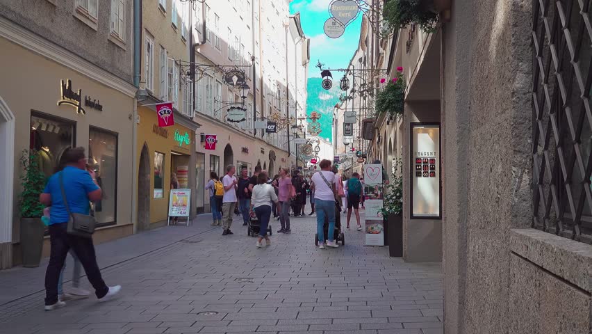 Salzburg , Salzburg , Austria - 09 01 2022: Shoppers and tourists, Getreidegasse, main shopping street, (part 1 of 3)