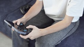 A woman plays a game on her phone with a joystick.