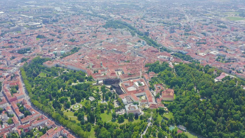Inscription on video. Graz, Austria. The historic city center aerial view. Mount Schlossberg (Castle Hill). Flames with dark fire, Aerial View, Departure of the camera