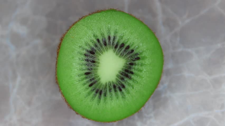 Ripe sliced kiwi on table. Top view video.