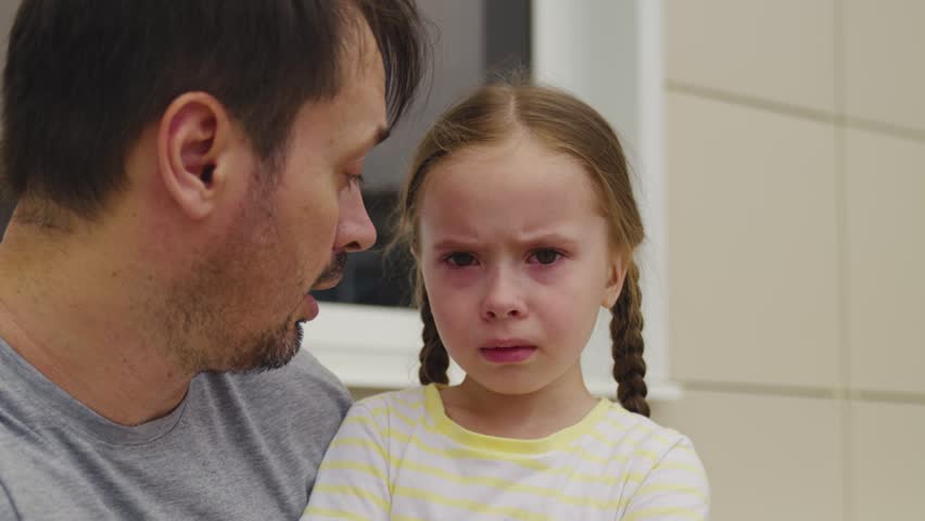 Little girl crying. child does not listen dad. conflict between father kid daughter. tears upset child. bad emotions capricious kid. scandal between parent child outdoors. defend your child opinion. | Shutterstock HD Video #1099619469