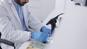 Science, research study and man with biotechnology and scientific tech, innovation and scientist with data analysis in lab. Study, doctor runs experiment and check sample, review results on monitor - Powered by Shutterstock - Get 15% off with code: PIKWIZARD15