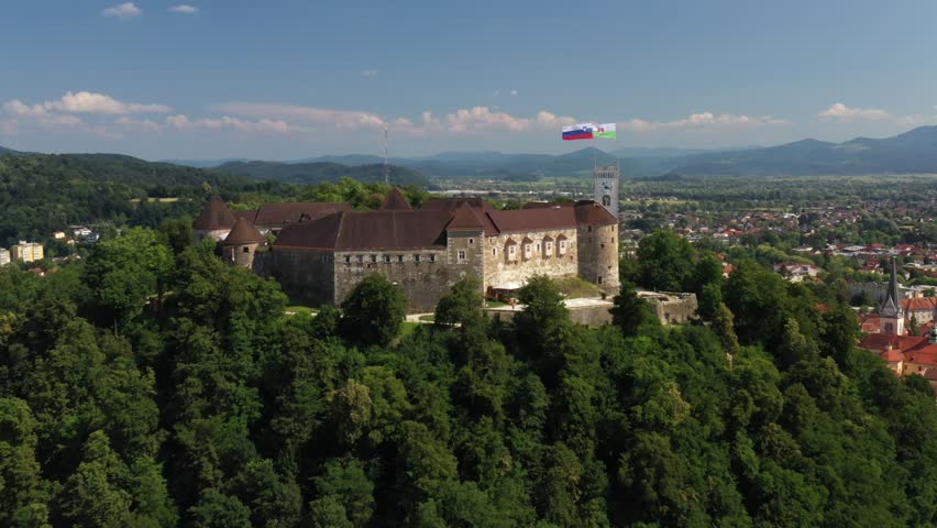 Ljubljana Castle and old town in Slovenia. Ljubljana is the largest city. It's known for its university population and green spaces, including expansive Tivoli Park. The curving Ljubljanica River. Royalty-Free Stock Footage #1099623813