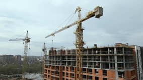 Tower cranes and frame structure of high residential apartment buildings at construction site. Real estate development - Powered by Shutterstock - Get 15% off with code: PIKWIZARD15