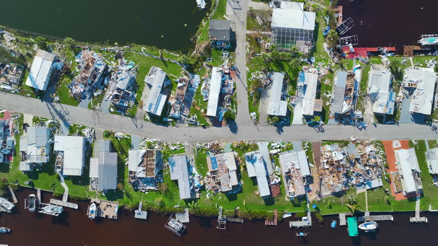 Severely damaged houses after hurricane Ian in Florida mobile home residential area. Consequences of natural disaster | Shutterstock HD Video #1099629055