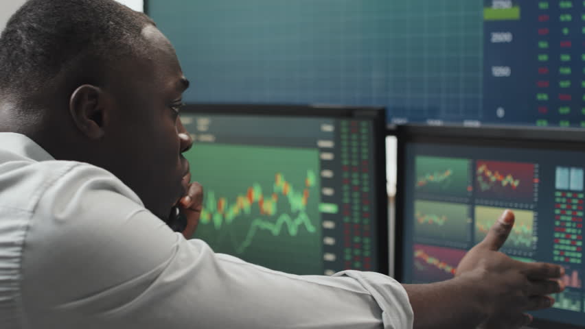 Young adult Black man working in stock trading agency feeling stressed out because of some problems explaining issue to client or colleague on phone call | Shutterstock HD Video #1099630379