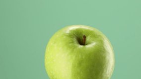 green apple on a green background. fresh fruit close-up. High quality 4k footage