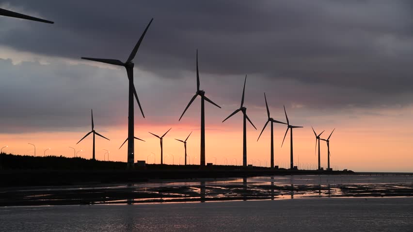 Sunset view of the Gaomei wetlands landscape and the wind power systems in Taichung, Taiwan. energy systems and renewable energy.