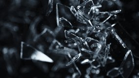 Super Slow Motion Shot of Shattering Glass Shards Flying Towards Camera on Black at 1000fps. - Powered by Shutterstock - Get 15% off with code: PIKWIZARD15