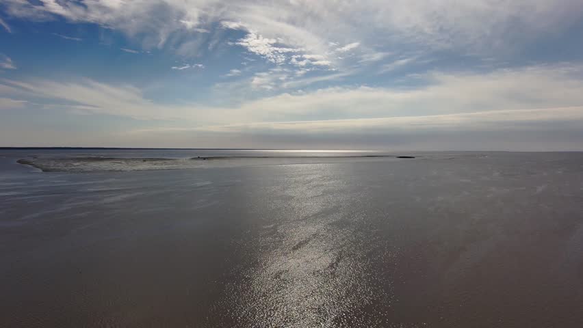 Aerial footage of a gorgeous sunrise over Mobile Bay and the USS Alabama and a gorgeous blue sky with clouds in Mobile Alabama USA
